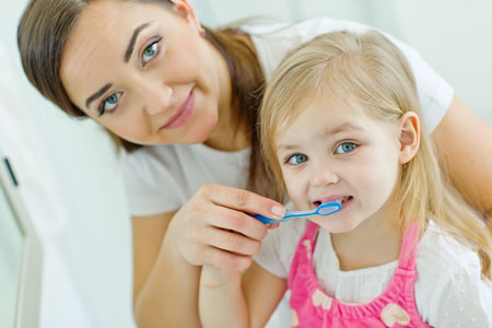 Mom and Daughter brushing their teeth - Pediatric Dentistry and Orthodontics in Burbank, CA