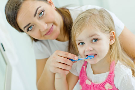 Mom and Daughter brushing their teeth - Pediatric Dentistry and Orthodontics in Burbank, CA